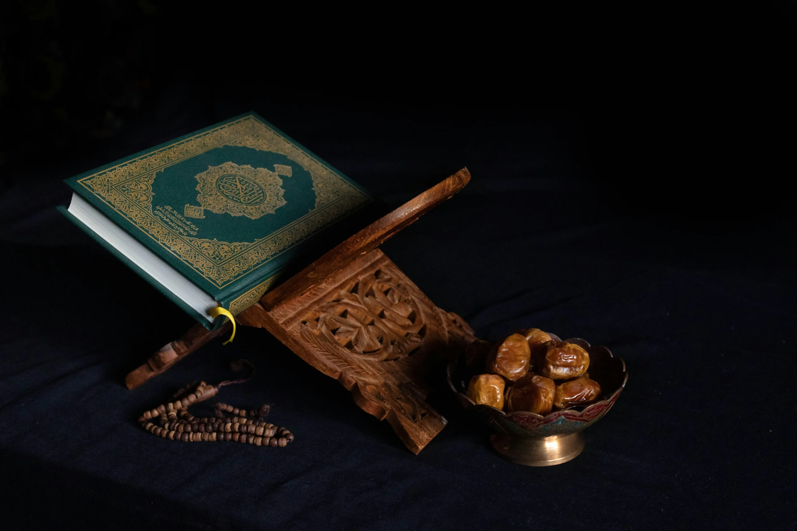 abdullah-arif-Dxi6KbpvUgA-unsplash Rows of Muslims praying Taraweeh inside a mosque with carpeted floor and prayer mats during Ramadan night.