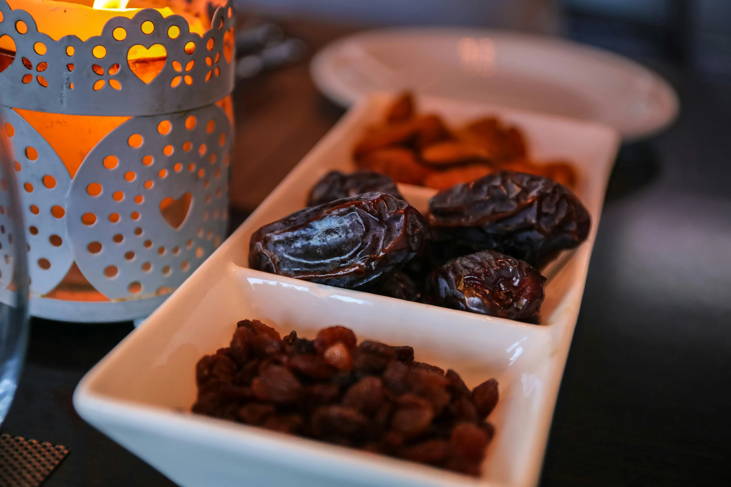 pexels-naimbic-2291592 fresh dates and a glass of water placed on a table, traditional foods for breaking fast during Ramadan.