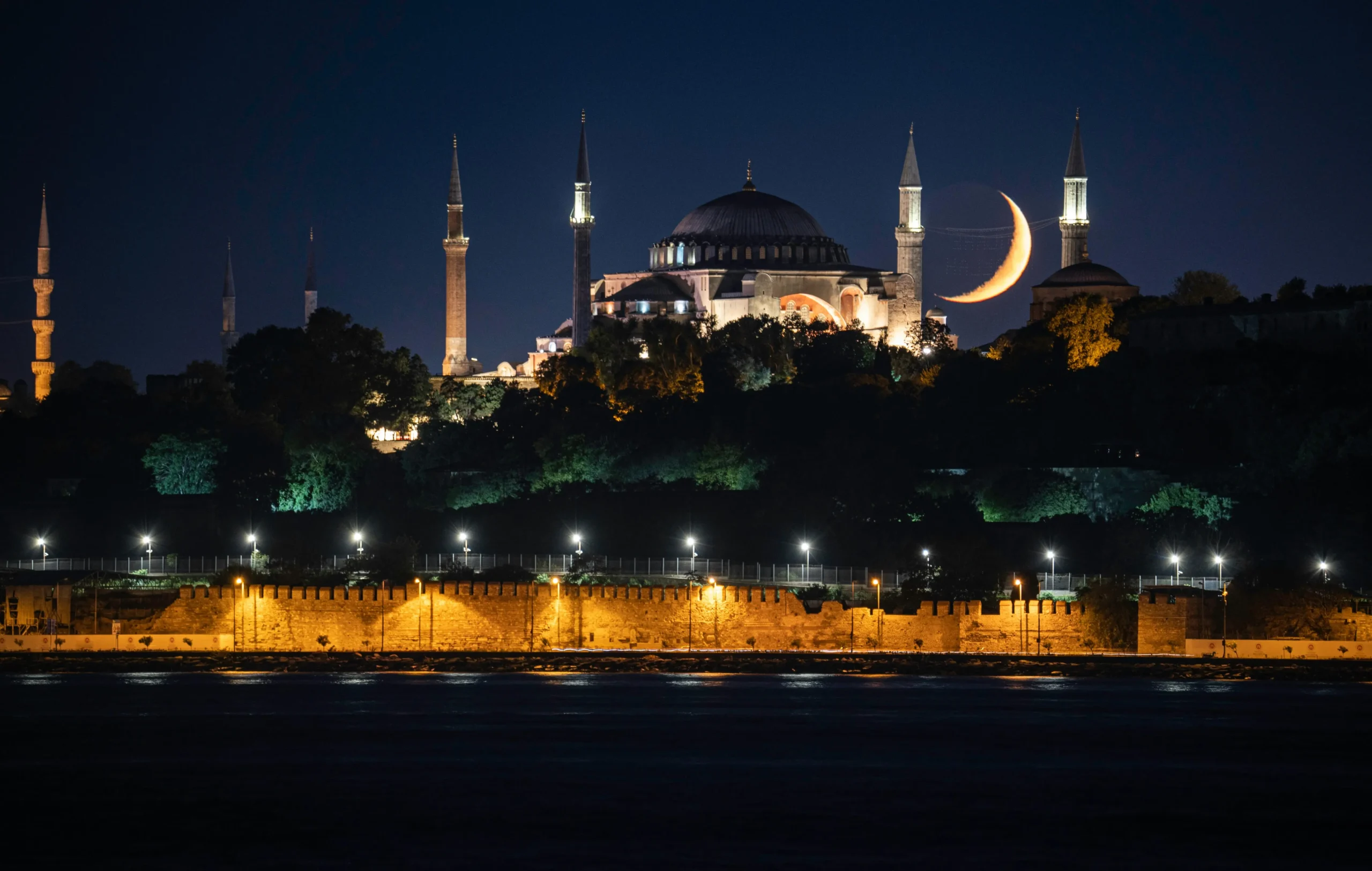 Blue Mosque The Blue Mosque illuminated at night, with a bright moon overhead, celebrating Eid al-Fitr's festive atmosphere
