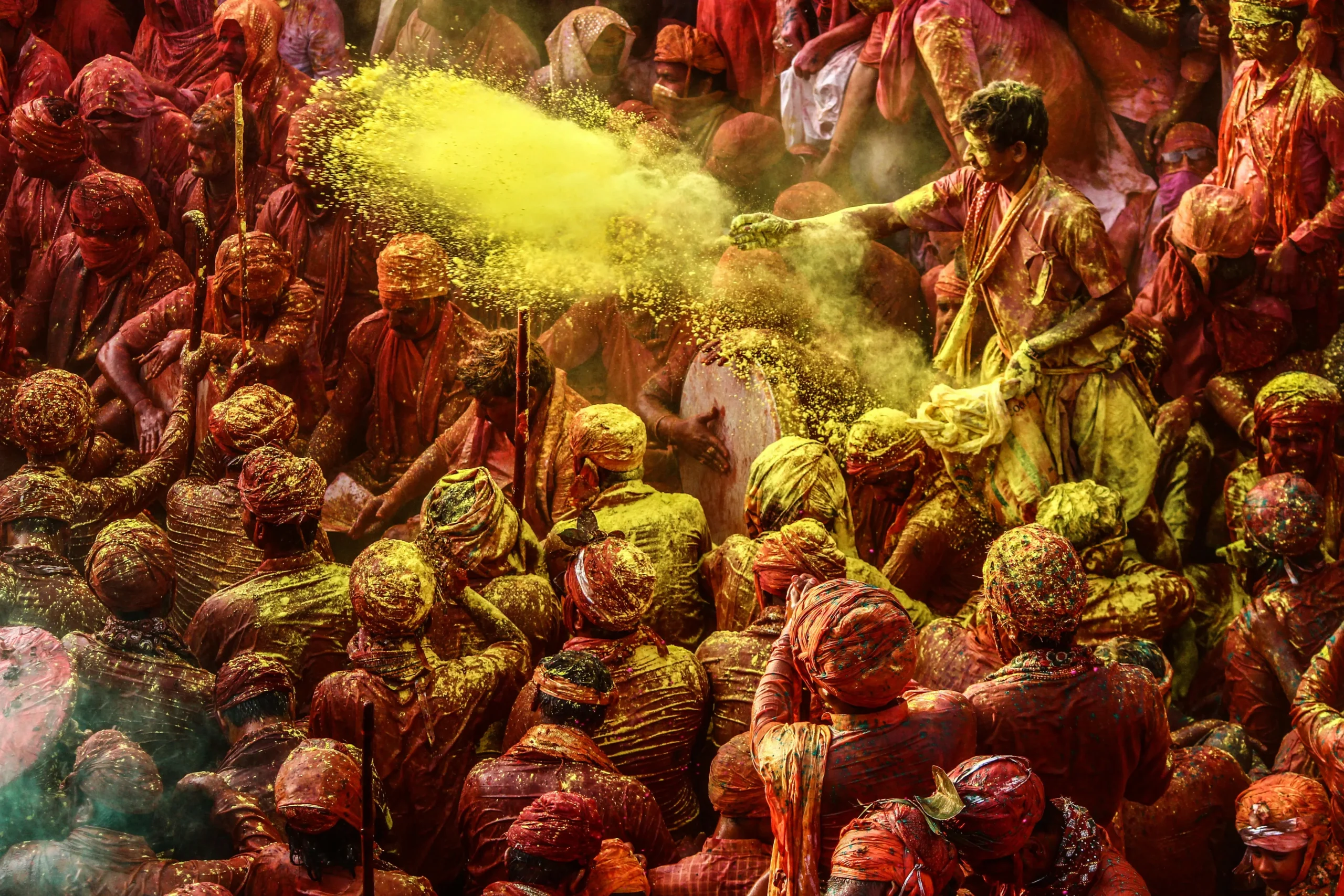 Holi Yellow Color A group of people covered in yellow Color, engaged in an Holi activity involving Throwing colors on each other on the occasion of Holi