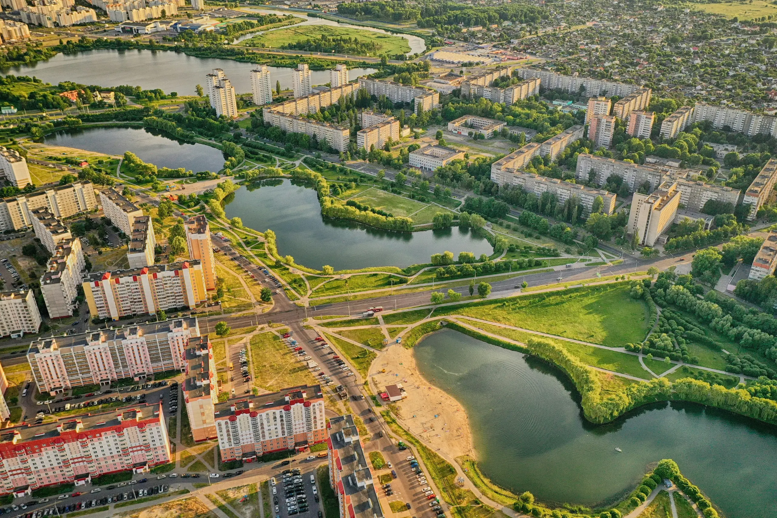 A modern cityscape of Minsk, Belarus, featuring tall buildings, wide streets, and urban architecture under a clear sky.