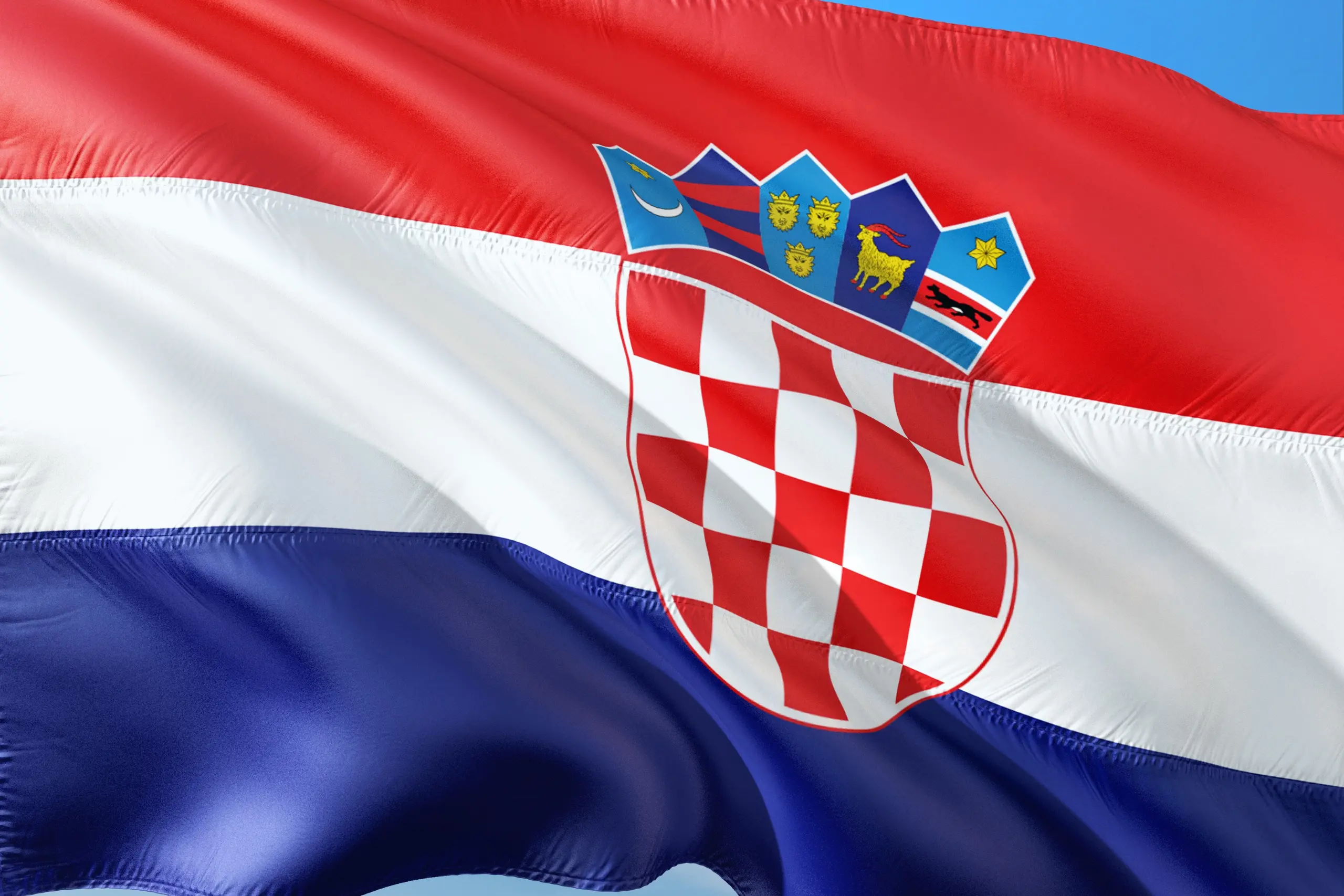 National flag of Croatia waving with red, white, and blue colors and coat of arms