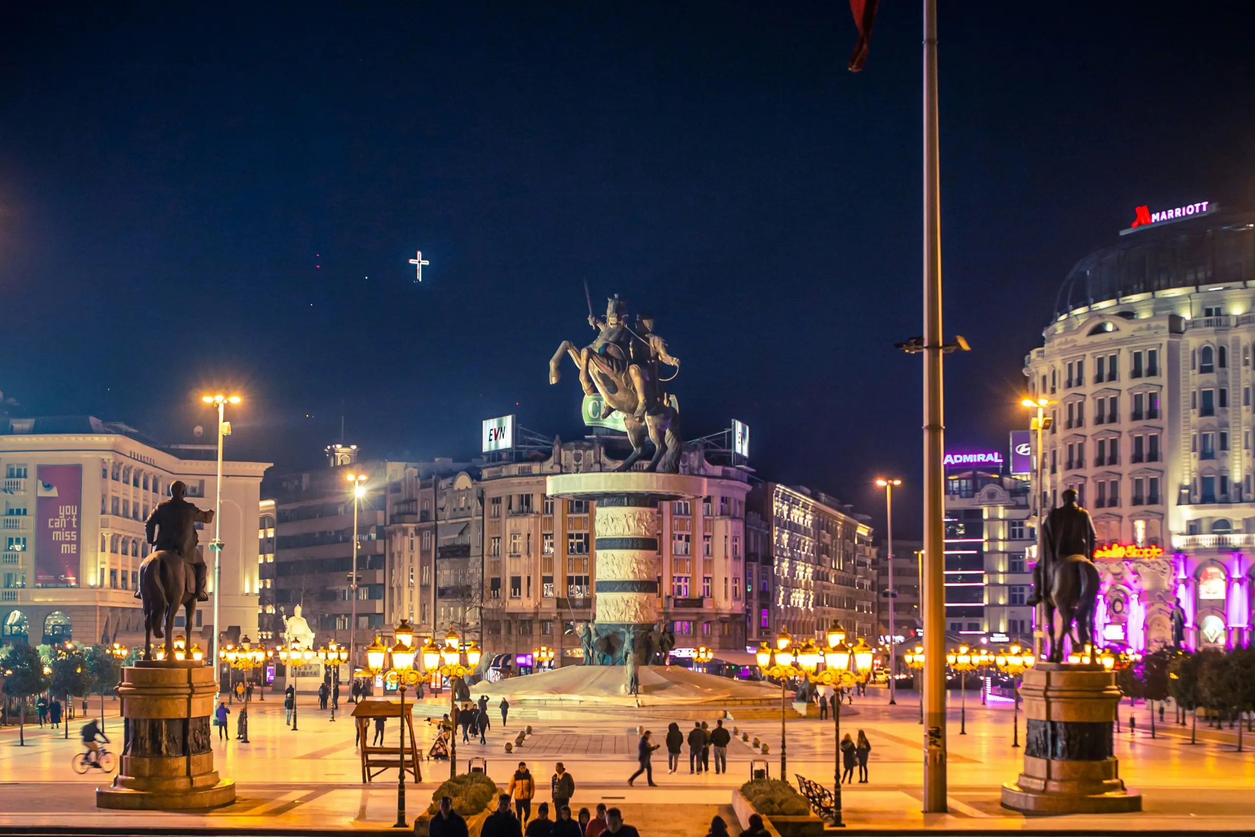 Christmas tree adorned with a sparkling silver star, golden angel, red baubles, and a string of gold beads, evoking a joyful holiday mood.