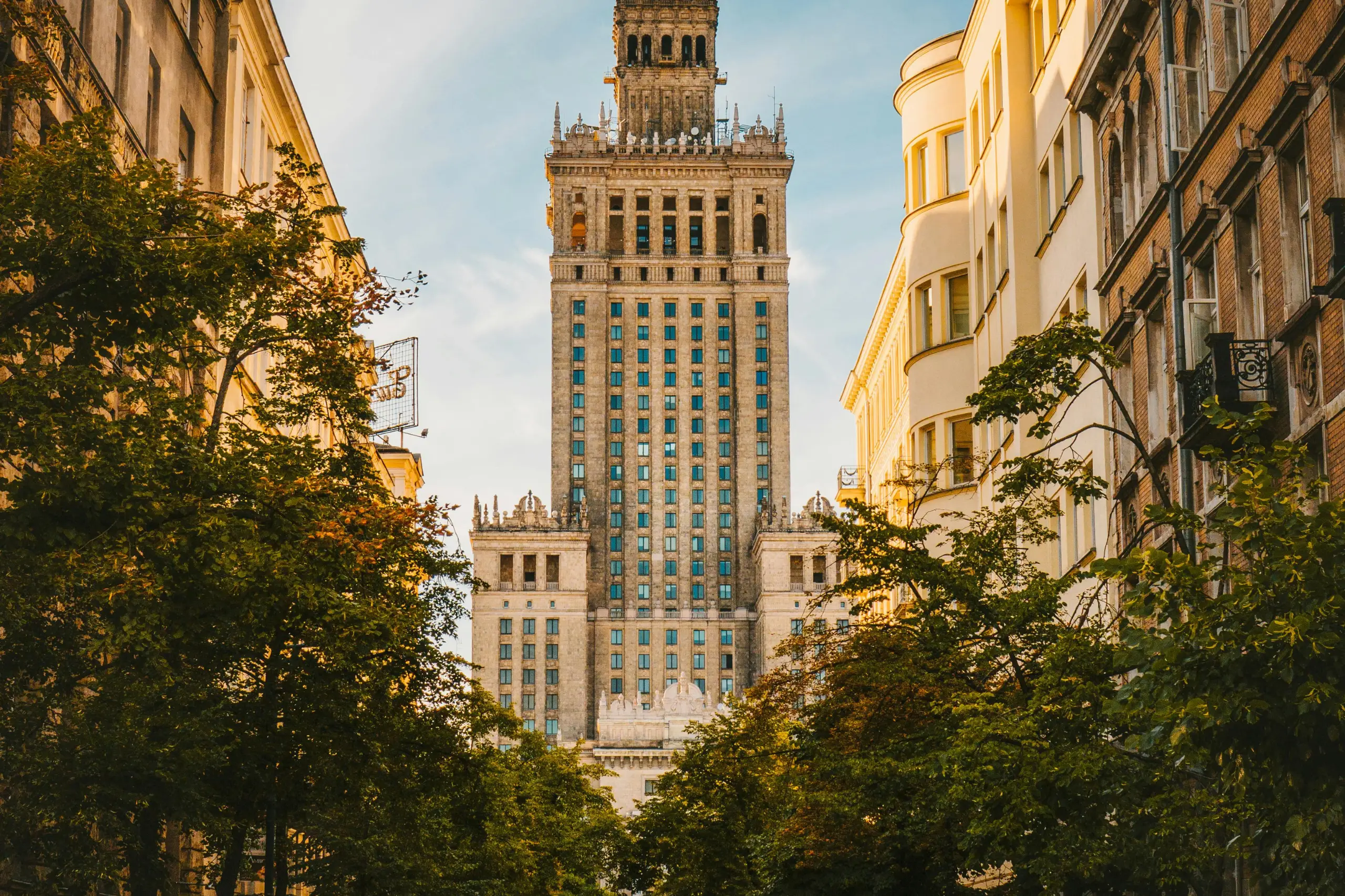 Christmas tree adorned with a sparkling silver star, golden angel, red baubles, and a string of gold beads, evoking a joyful holiday mood.