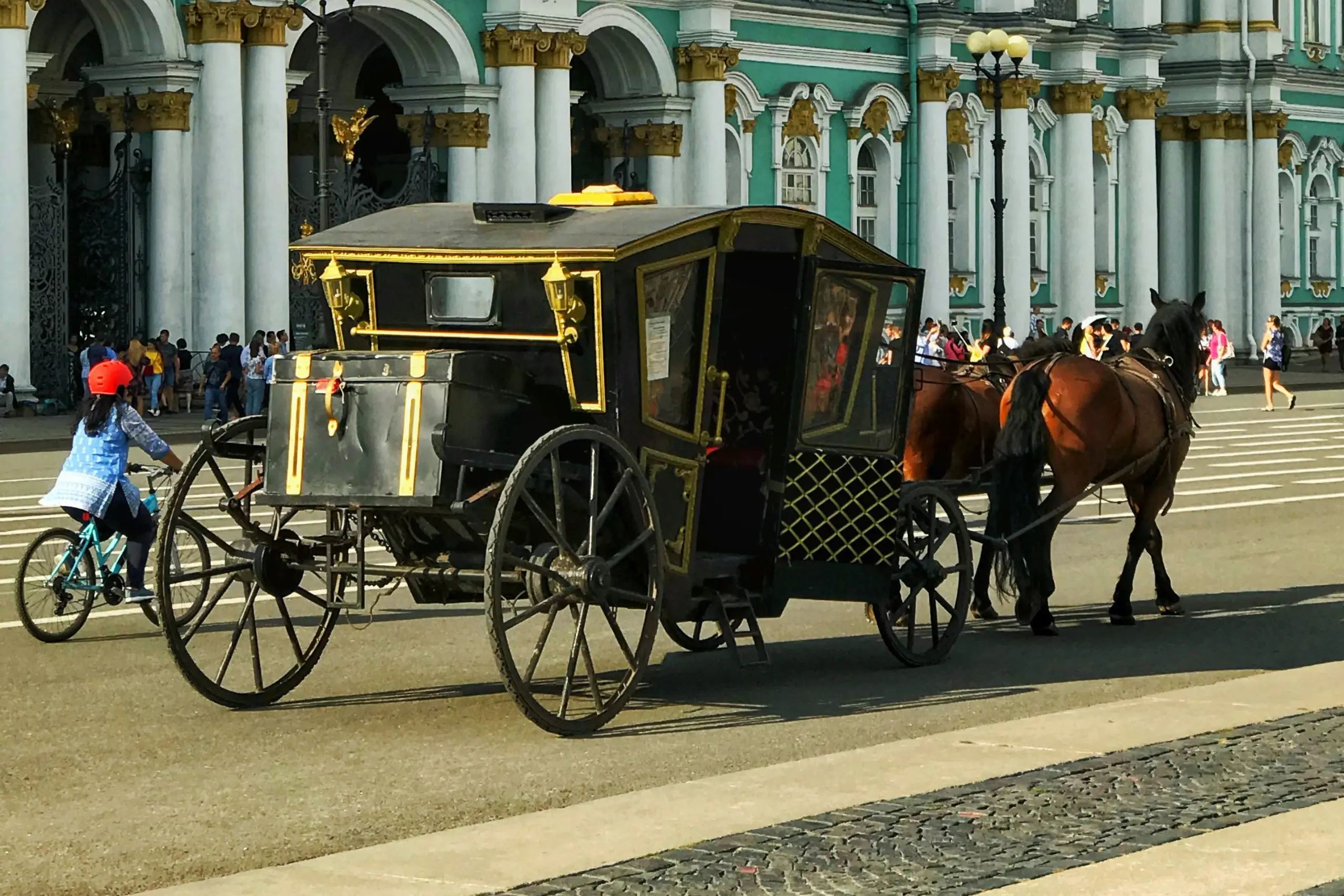 An individual decorates a Christmas tree with various ornaments, creating a joyful holiday atmosphere.