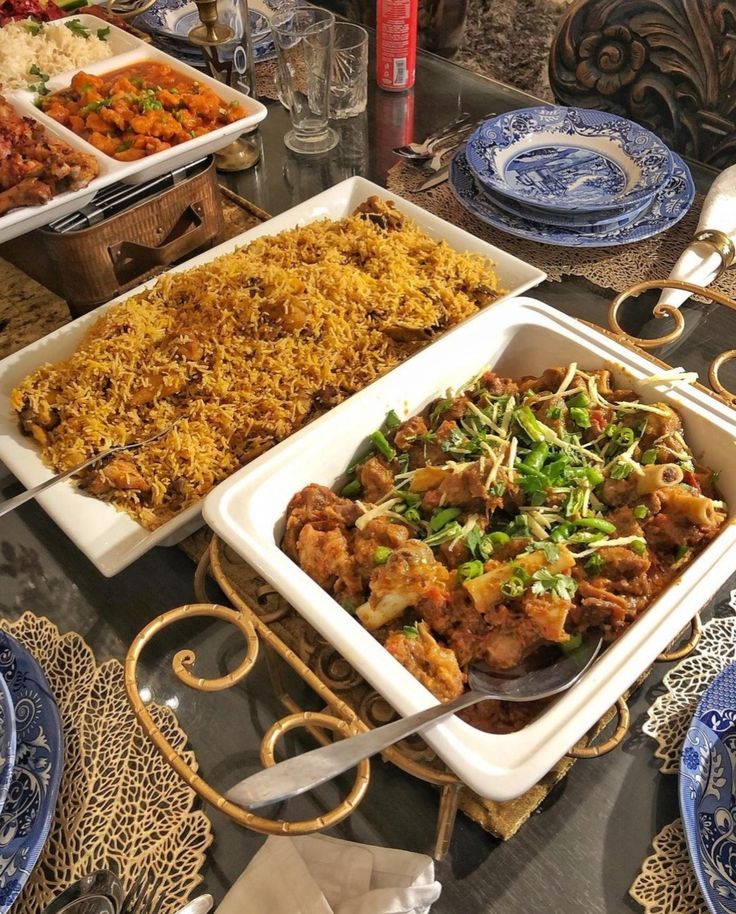 A festive dining table with steaming biryani and creamy chicken korma dishes prepared for the Eid feast