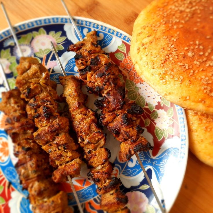  Grilled seekh kebabs served with mint chutney and onions on Eid al-Adha dinner table